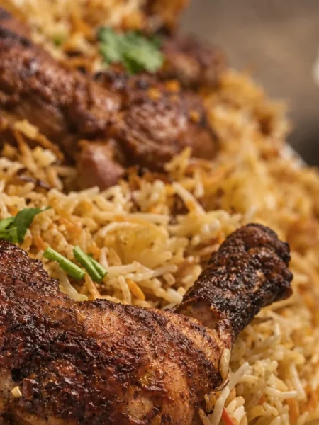 Chicken biryani with saffron-gold basmati rice and browned chicken.