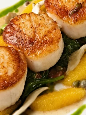 Seared Scallops on Grapefruit with a Pea Accompaniment, prepared and ready to serve.