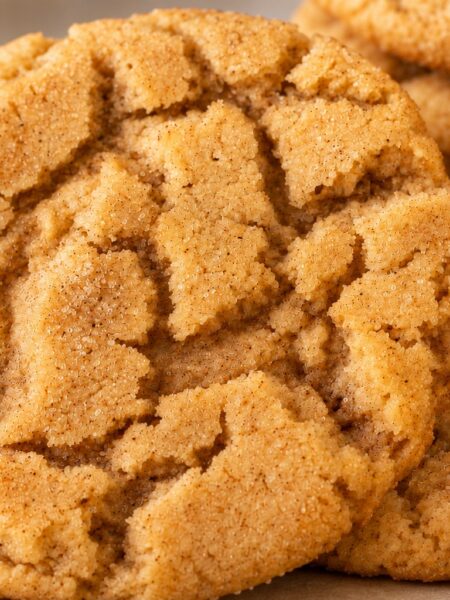 Rustic golden cinnamon and brown sugar crinkle cookies with naturally cracked tops.
